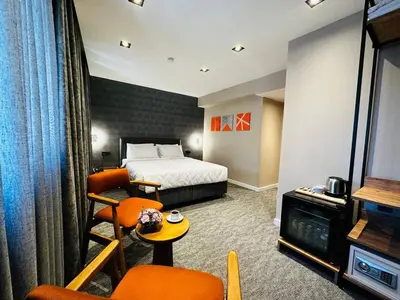 a hotel room with a bed and a table and chairs at Taksim REXXEE Istanbul Istiklal Hotel in Istanbul