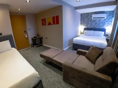 a hotel room with a couch and a bed at Taksim REXXEE Istanbul Istiklal Hotel in Istanbul