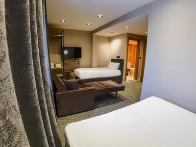a hotel room with a bed and a couch at Taksim REXXEE Istanbul Istiklal Hotel in Istanbul