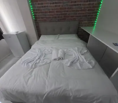 a white bed in a room with a brick wall at lastbest hotel in Istanbul