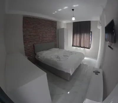a bedroom with a bed and a brick wall at lastbest hotel in Istanbul