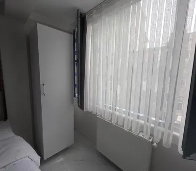 a bedroom with a window with white curtains and a bed at lastbest hotel in Istanbul