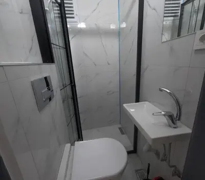 a white bathroom with a toilet and a sink at lastbest hotel in Istanbul