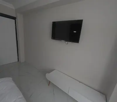 a flat screen tv on a wall in a bedroom at lastbest hotel in Istanbul