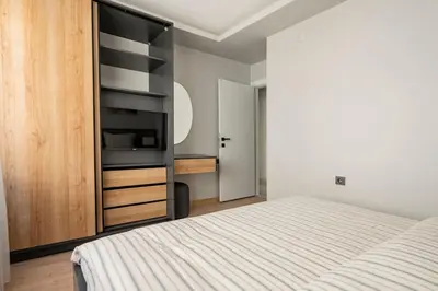 a bedroom with a bed and a wooden cabinet at Tomtom HOUSE Centre Location in Istanbul