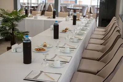 a long white table with chairs and plates of food at Gorukle Oruc Hotel in Bursa