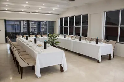 a large dining room with white tables and chairs at Gorukle Oruc Hotel in Bursa