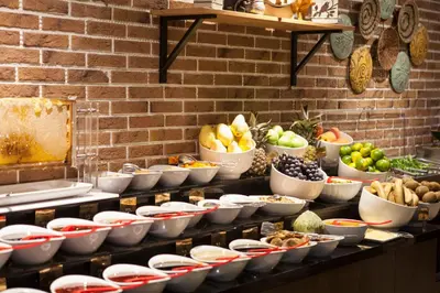 a buffet line with bowls of fruits and vegetables at Gorukle Oruc Hotel in Bursa