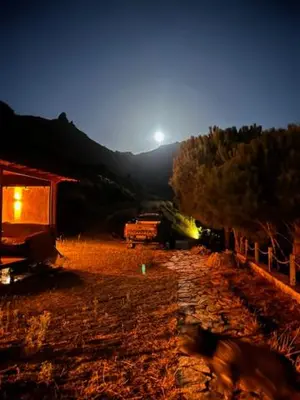 a night view of a field with a house and trees at MOLA villas&suites in Marmara