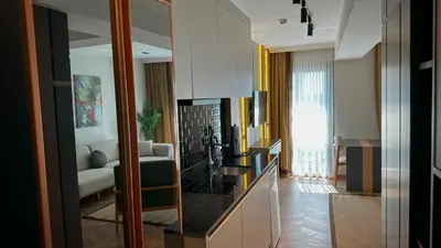 a living room with a fireplace and a couch at Shiboo Suite Otel in Gebze