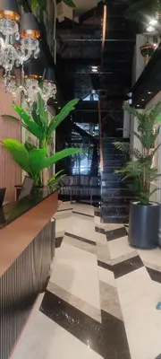 a lobby with plants and stairs in a building at Shiboo Suite Otel in Gebze