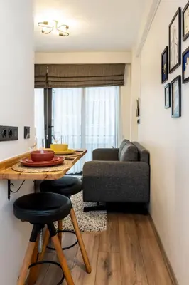 a living room with a table and a couch at Mariposa Rooms Taksim in Istanbul