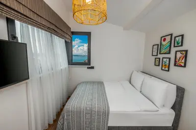 a living room with a white couch and a flat screen tv at Mariposa Rooms Taksim in Istanbul