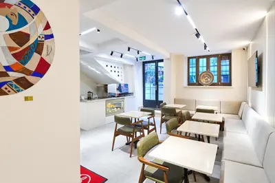 a restaurant with tables and chairs and a couch at Thank You Hotel Sultanahmet in Istanbul