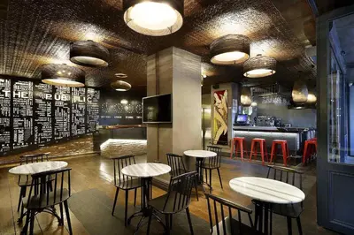 a bar with tables and stools in a restaurant at Hotel The Public - Special Category in Istanbul