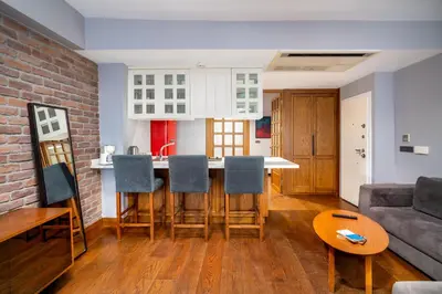 a kitchen and living room with a brick wall at Urban Quarters - Asmalı Mescit in Istanbul