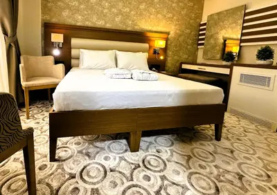 a bedroom with a bed and a chair and a desk at AQUA MARINN SPA&WELLNESS in Yalova