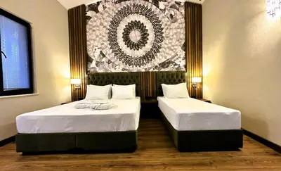 two beds in a room with a painting on the wall at AQUA MARINN SPA&WELLNESS in Yalova