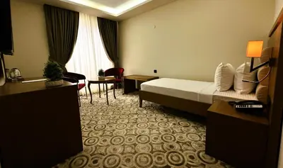 a hotel room with a bed and a table and chairs at AQUA MARINN SPA&WELLNESS in Yalova