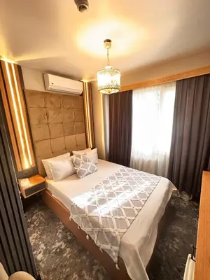 a bedroom with a bed and a chandelier at Taksim Cetinkaya Suite in Istanbul
