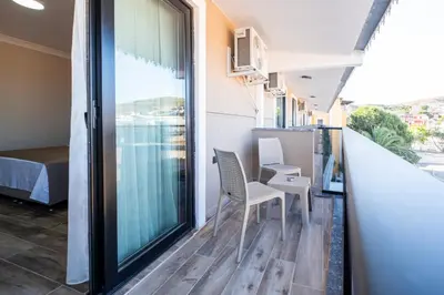 a balcony with two chairs and a table at Avsa Artemis Hotel in Avsa Adasi