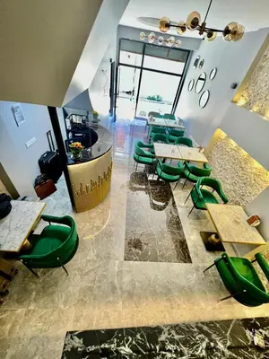 a restaurant with green chairs and tables in a room at dolphin hotel cafe in Istanbul