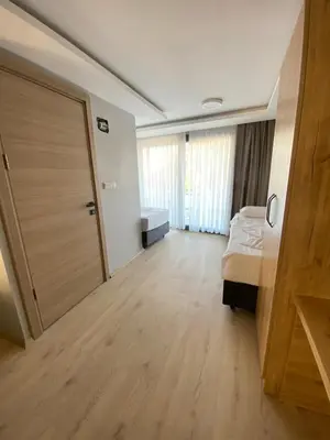 a bedroom with a bed and a sliding door at dolphin hotel cafe in Istanbul