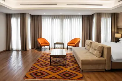 a hotel room with a bed and a couch at Riva Hotel Nişantaşı in Istanbul