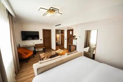 a hotel room with a bed and a living room at Riva Hotel Nişantaşı in Istanbul