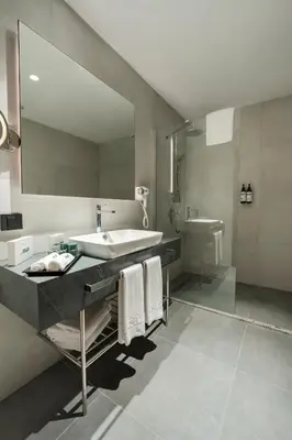 a bathroom with a sink and a mirror at Riva Hotel Nişantaşı in Istanbul
