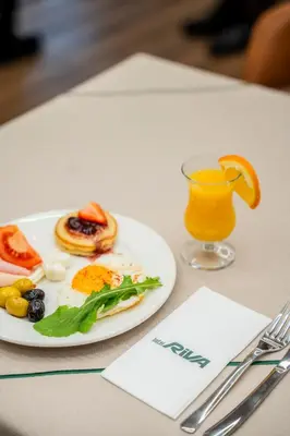 a plate of breakfast food and a glass of orange juice at Riva Hotel Nişantaşı in Istanbul