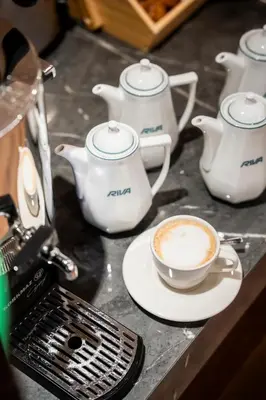 a cup of coffee and teapots on a counter at Riva Hotel Nişantaşı in Istanbul