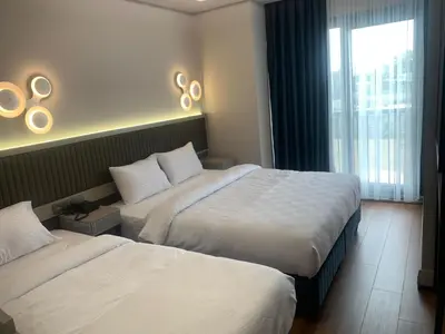 a hotel room with two beds and a window at Theodosius Hotel in Istanbul