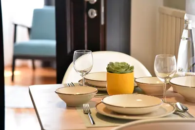 a table with plates and wine glasses on it at İstanbul Guesthouse in Istanbul