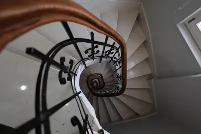 a spiral stair case with a spiral staircase at İstanbul Guesthouse in Istanbul