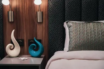 a bedroom with a bed and two vases on a table at No25 Suites Nisantasi in Istanbul