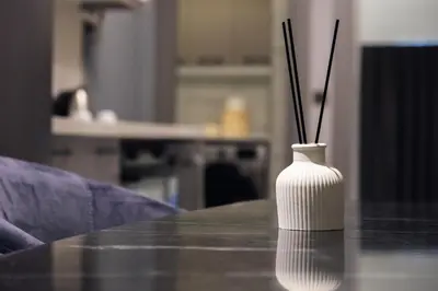 a white vase with sticks in it on a table at No25 Suites Nisantasi in Istanbul