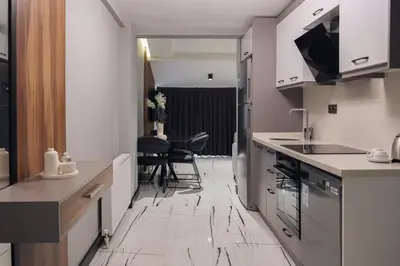 a kitchen with a counter and a table and chairs at No25 Suites Nisantasi in Istanbul