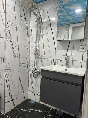 a white bathroom with a sink and a mirror at IMMOR AKKUS HOTEL in Istanbul