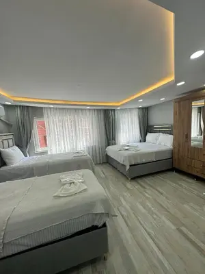 a bedroom with two beds in a room with wooden floors at IMMOR AKKUS HOTEL in Istanbul