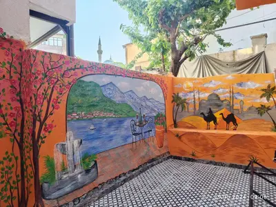 a wall with a mural of cats on a bed at IMMOR AKKUS HOTEL in Istanbul