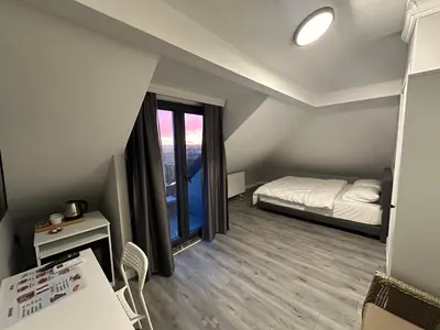 a small room with a bed and a window at ASLAN AİRPORT Hotel in Arnavutköy
