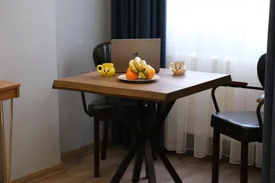 a wooden table with a plate of fruit on it at Elita Otel Kumkapı in Istanbul