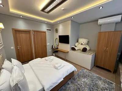 a bedroom with a teddy bear sitting on a bed at Elita Otel Kumkapı in Istanbul