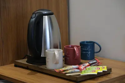 a coffee maker and two mugs on a table at Elita Otel Kumkapı in Istanbul