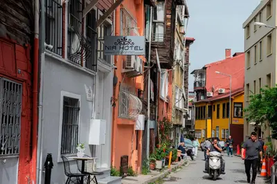a group of people walking down a narrow street at NİA SULTANAHMET in Istanbul