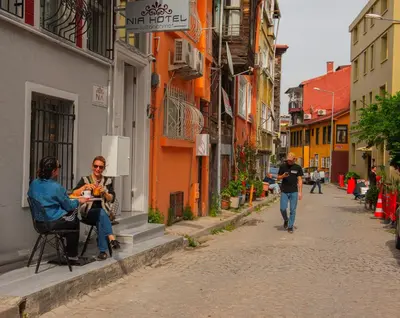 a group of people sitting at a table on a street at NİA SULTANAHMET in Istanbul