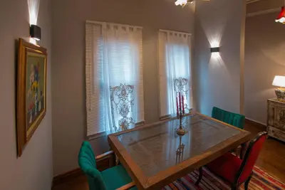 a dining room with a wooden table and green chairs at NİA SULTANAHMET in Istanbul