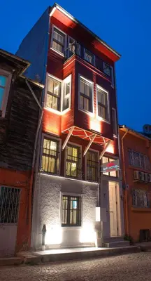 a tall building with lights on the side of it at NİA SULTANAHMET in Istanbul
