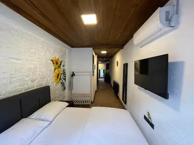 a room with a bed and a tv on a wall at Casa Mirasol Terrace Golden Horn Istanbul in Istanbul